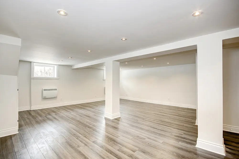 Spacious basement remodel in Montreal with modern flooring and open layout
